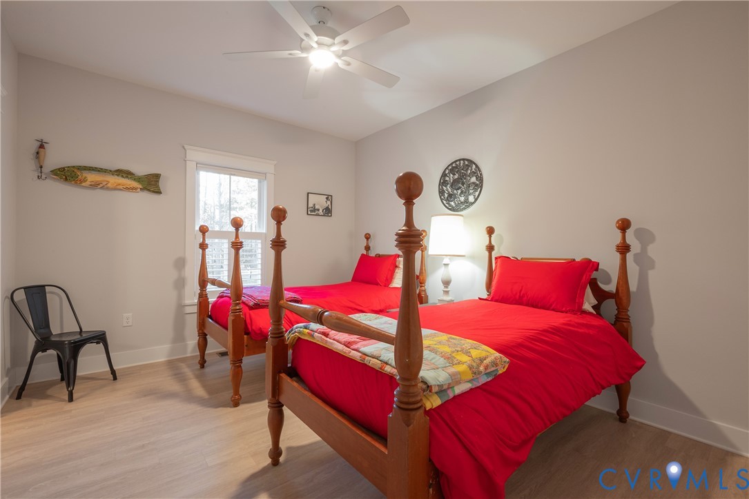 2591 Shaughnessy Road Powhatan, VA 23139 - Photo 35 of 50 a bedroom with a bed and a chandelier