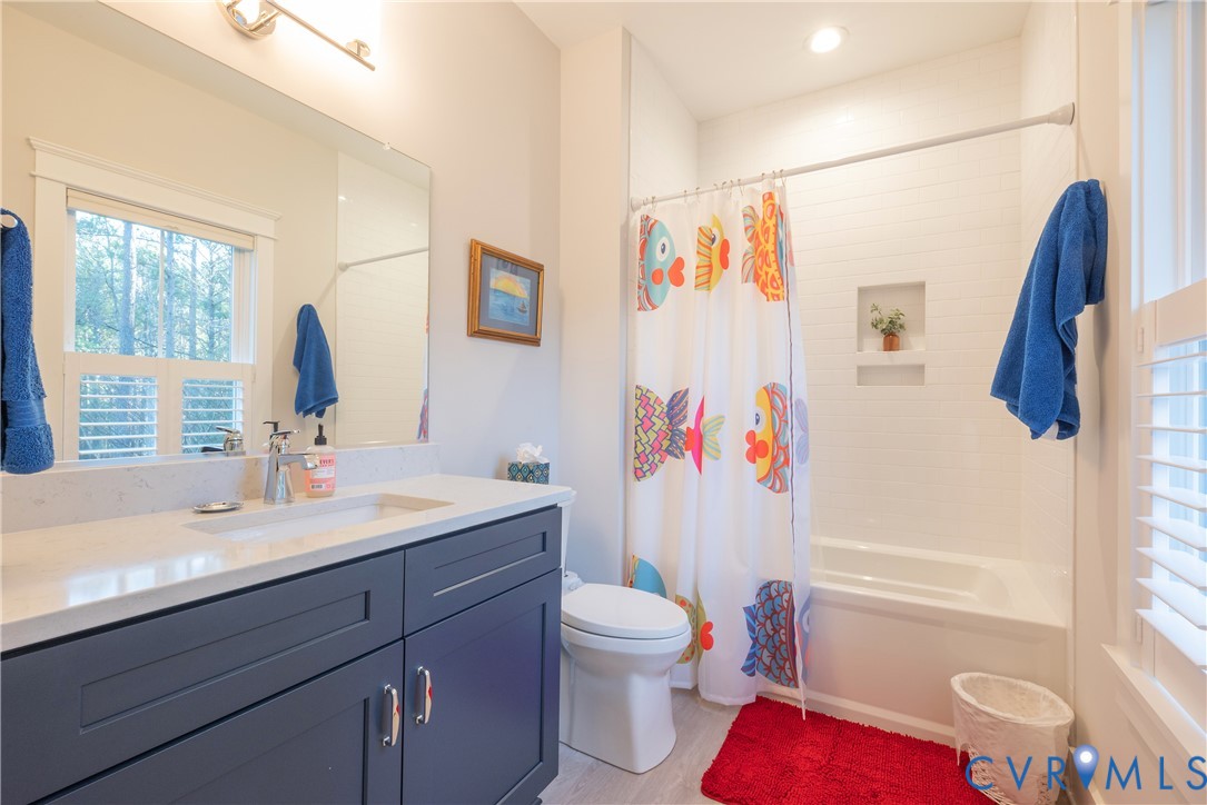 2591 Shaughnessy Road Powhatan, VA 23139 - Photo 36 of 50 a bathroom with a sink a toilet and a large mirror