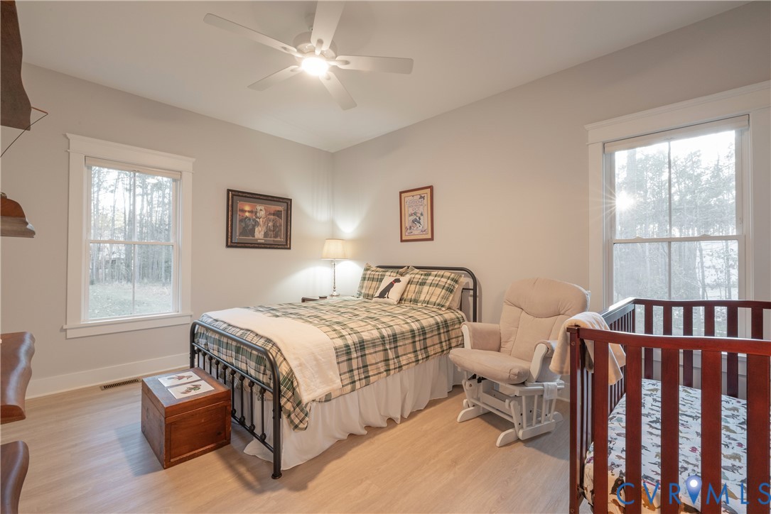 2591 Shaughnessy Road Powhatan, VA 23139 - Photo 39 of 50 a bedroom with a bed couch and windows