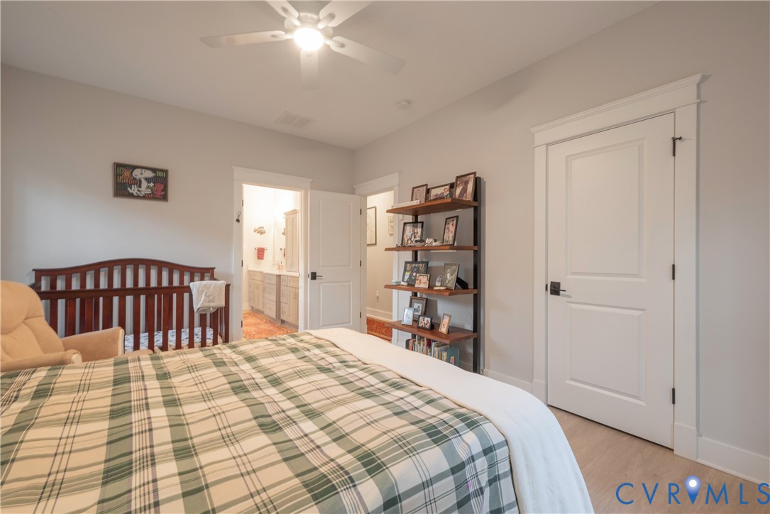 2591 Shaughnessy Road Powhatan, VA 23139 - Photo 40 of 50 a bedroom with a bed and a chandelier