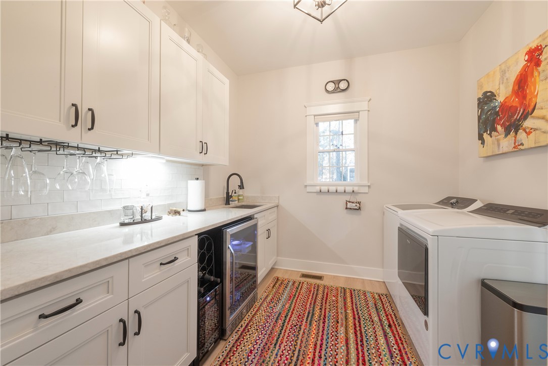 2591 Shaughnessy Road Powhatan, VA 23139 - Photo 46 of 50 a kitchen with a sink a stove and cabinets