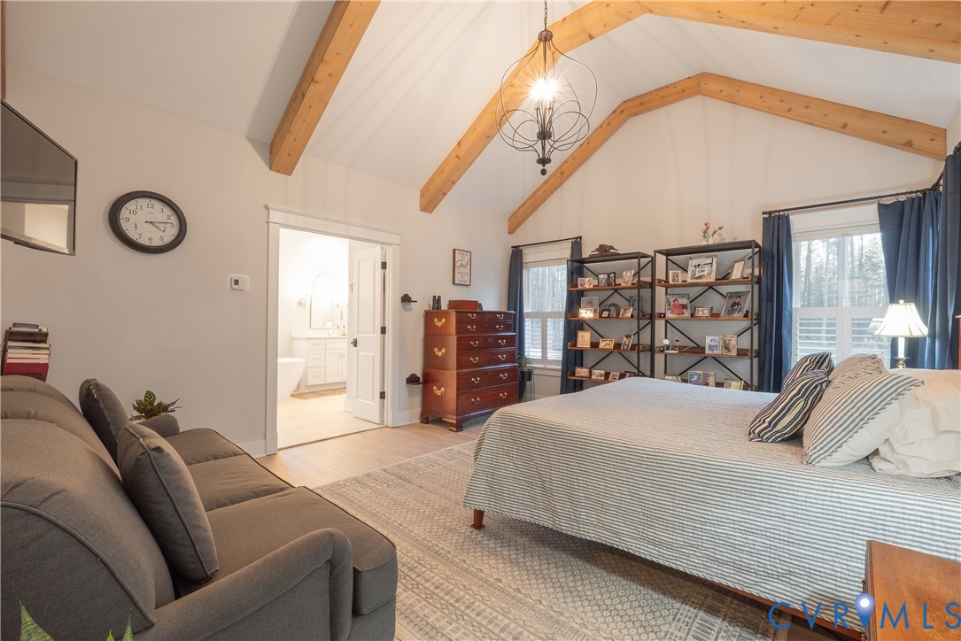 2591 Shaughnessy Road Powhatan, VA 23139 - Photo 47 of 50 a bedroom with a large bed and a chandelier