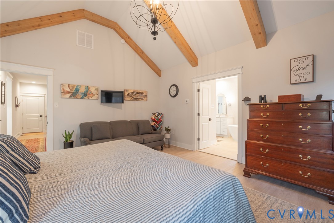 2591 Shaughnessy Road Powhatan, VA 23139 - Photo 48 of 50 a bedroom with a bed and a chandelier