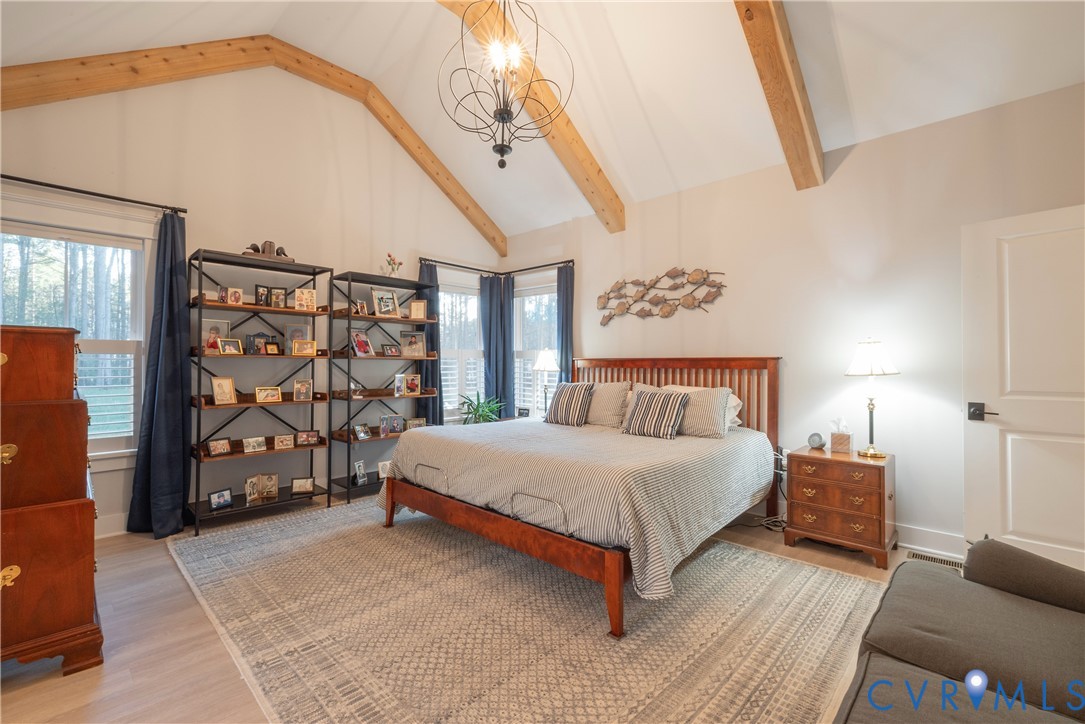 2591 Shaughnessy Road Powhatan, VA 23139 - Photo 49 of 50 a bedroom with a bed lamp and a potted plant