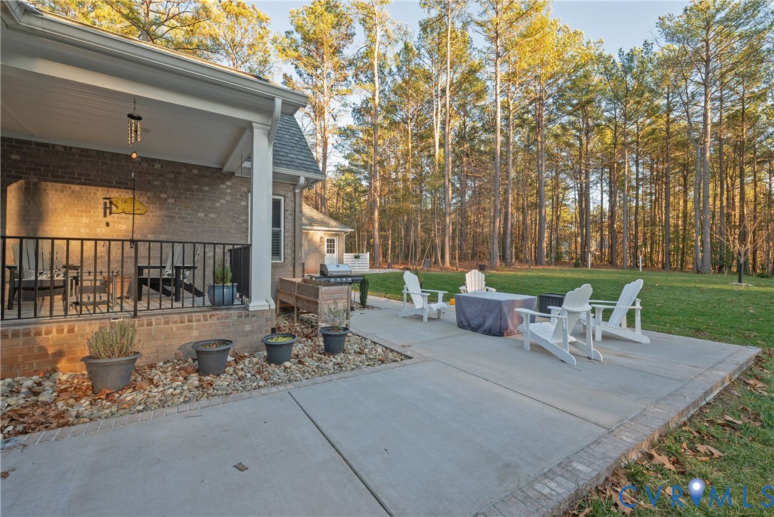 2591 Shaughnessy Road Powhatan, VA 23139 - Photo 9 of 50 a view of a patio with a table chairs and a fire pit