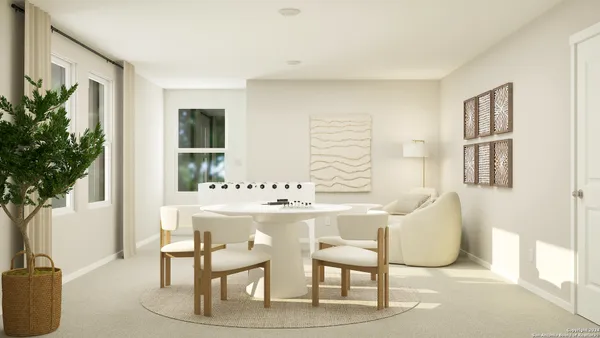 a view of a dining room with furniture and a potted plant