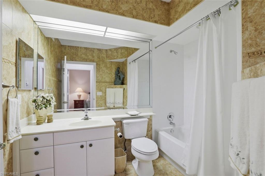 23820 San Marino Road, Unit 102 Estero, FL 34135 - Photo 21 of 28 Bathroom with shower / bath combo and vanity