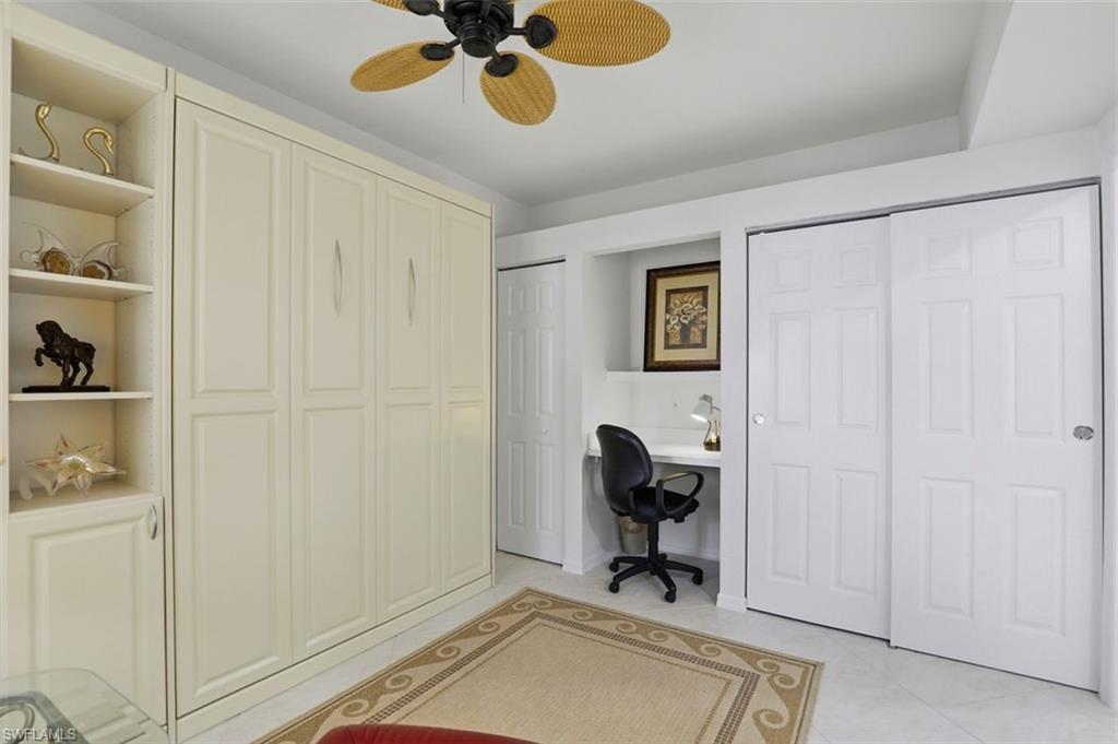 23820 San Marino Road, Unit 102 Estero, FL 34135 - Photo 24 of 28 Office featuring ceiling fan, light tile patterned floors, and built in desk