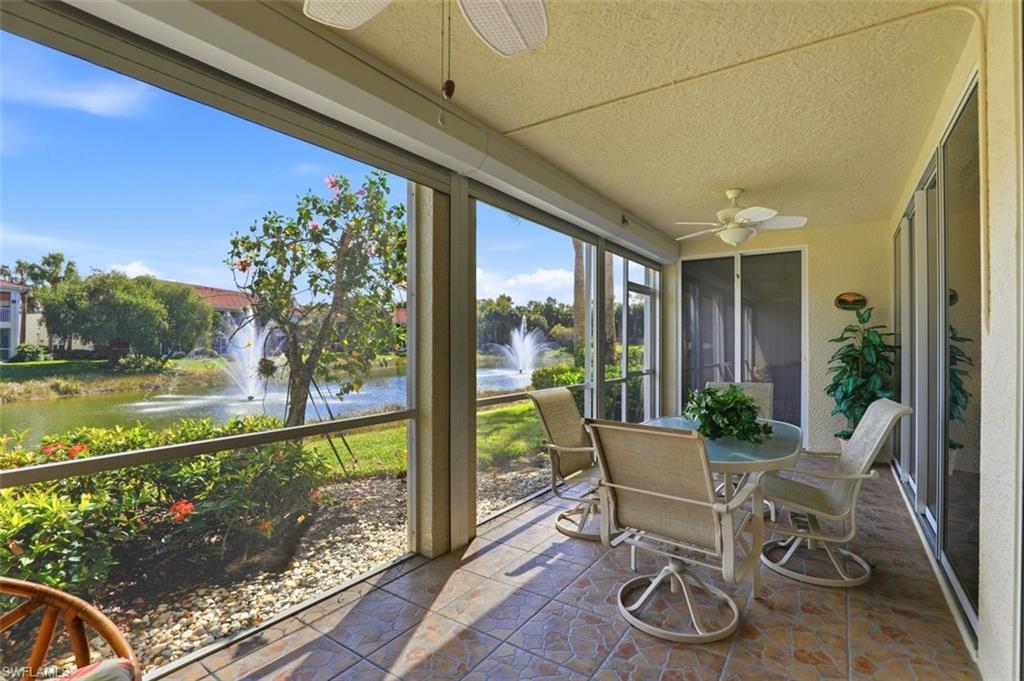 23820 San Marino Road, Unit 102 Estero, FL 34135 - Photo 6 of 28 Sunroom / solarium with ceiling fan, outdoor dining area, a water view, and stone finish floors