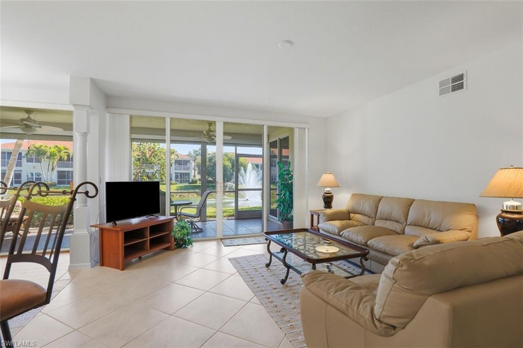 23820 San Marino Road, Unit 102 Estero, FL 34135 - Photo 10 of 28 Living room with ceiling fan and tile patterned floors