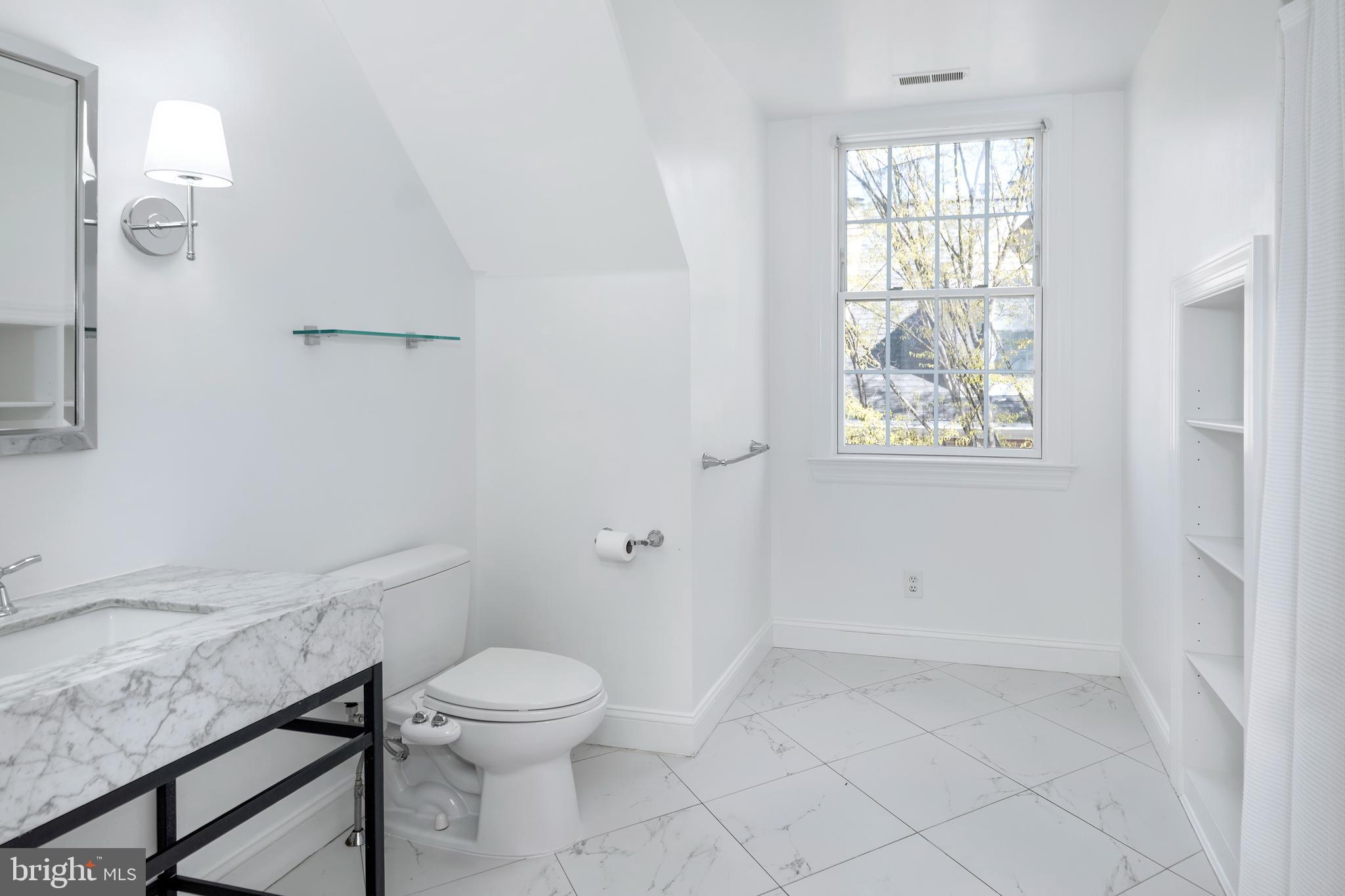 3 Governors Lane Princeton, NJ 08540 - Photo 20 of 26 a bathroom with a granite countertop toilet a sink and a window