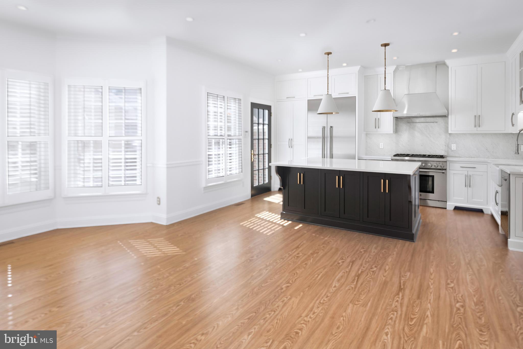 3 Governors Lane Princeton, NJ 08540 - Photo 7 of 26 a large kitchen with wooden floors and stainless steel appliances