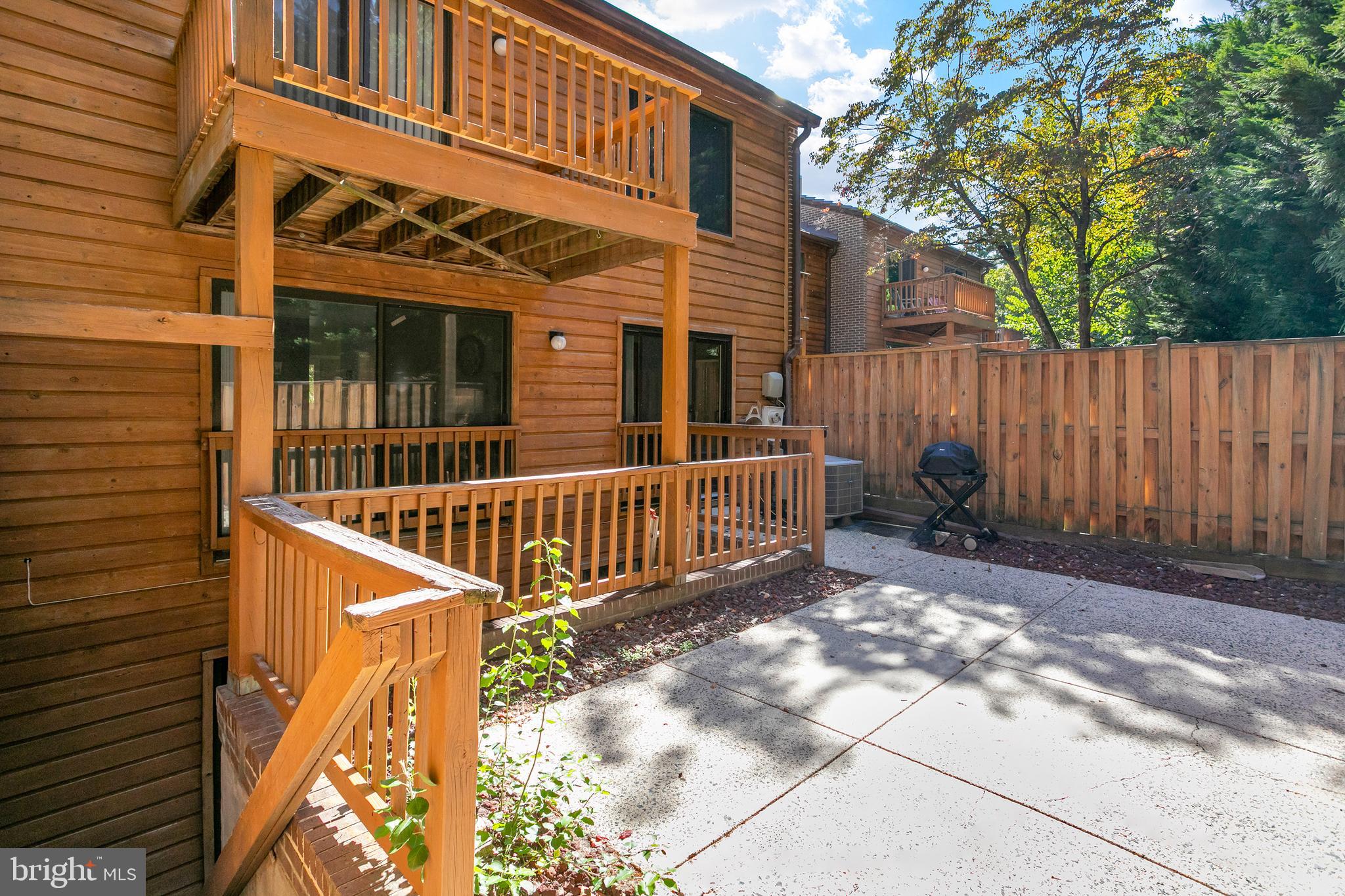 2213 Cedar Cove Court Reston, VA 20191 - Photo 19 of 40 outdoor view of a house with a small yard and wooden fence and trees