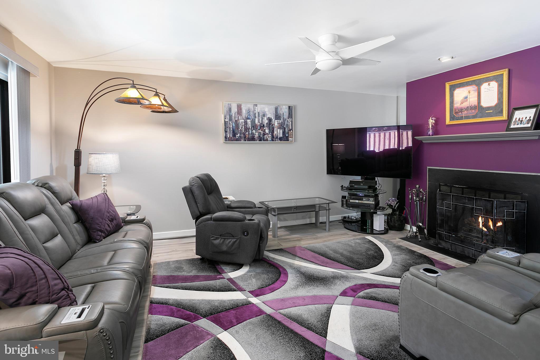 2213 Cedar Cove Court Reston, VA 20191 - Photo 3 of 40 a living room with furniture a flat screen tv and a fireplace