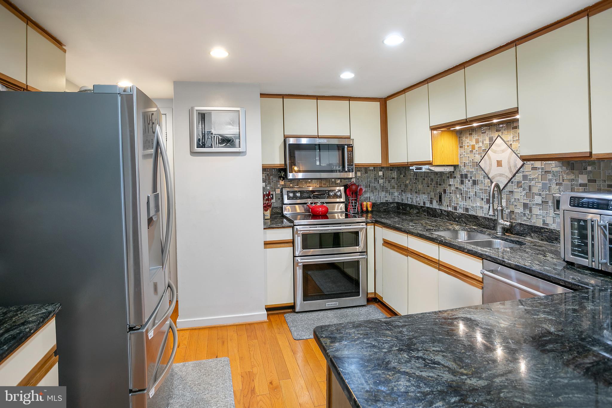 2213 Cedar Cove Court Reston, VA 20191 - Photo 4 of 40 a kitchen with stainless steel appliances granite countertop a refrigerator and a stove top oven