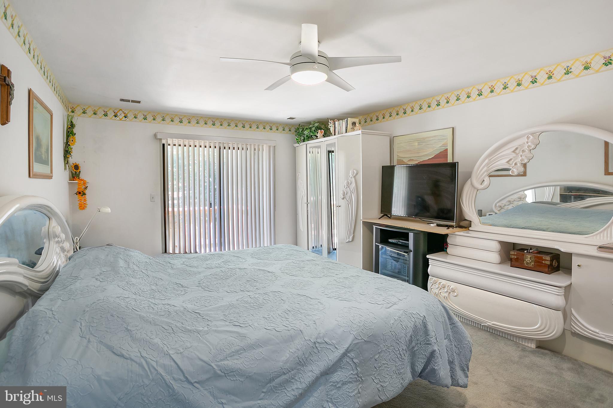 2213 Cedar Cove Court Reston, VA 20191 - Photo 10 of 40 a bedroom with a large bed and a flat tv screen on dresser