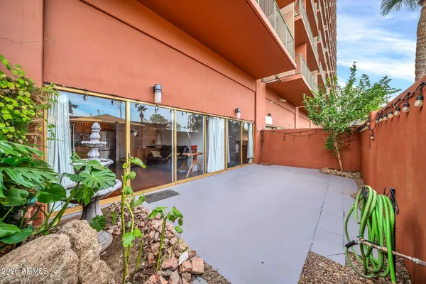 a dining hall with stainless steel appliances granite countertop a dining table chairs stove and white cabinets