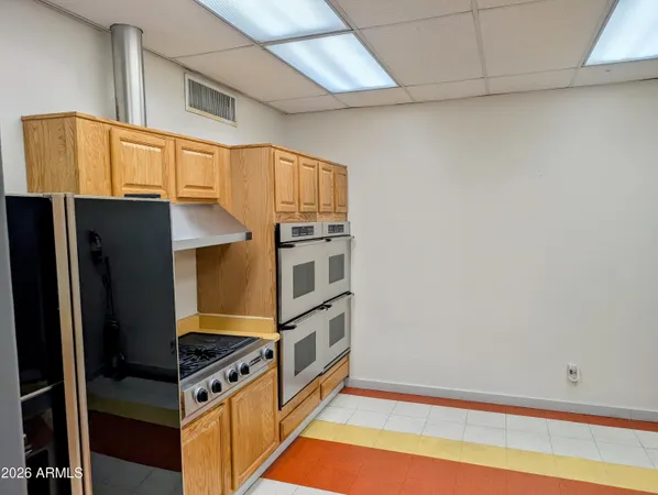 a view of a patio with a table and chairs and potted plants