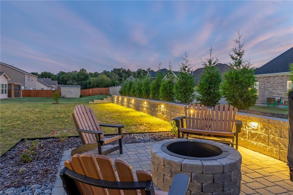 102 Radiant Path Trinity, NC 27370 - Photo 42 of 43 Lighted retaining wall with natural privacy screen
