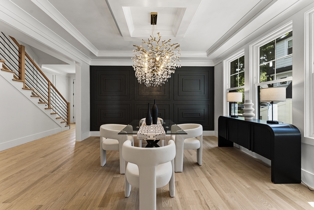 59 Henderson Street Needham, MA 02492 - Photo 11 of 32 a dining room with furniture a chandelier and wooden floor