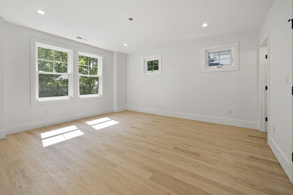 59 Henderson Street Needham, MA 02492 - Photo 21 of 32 a view of empty room with wooden floor and fan