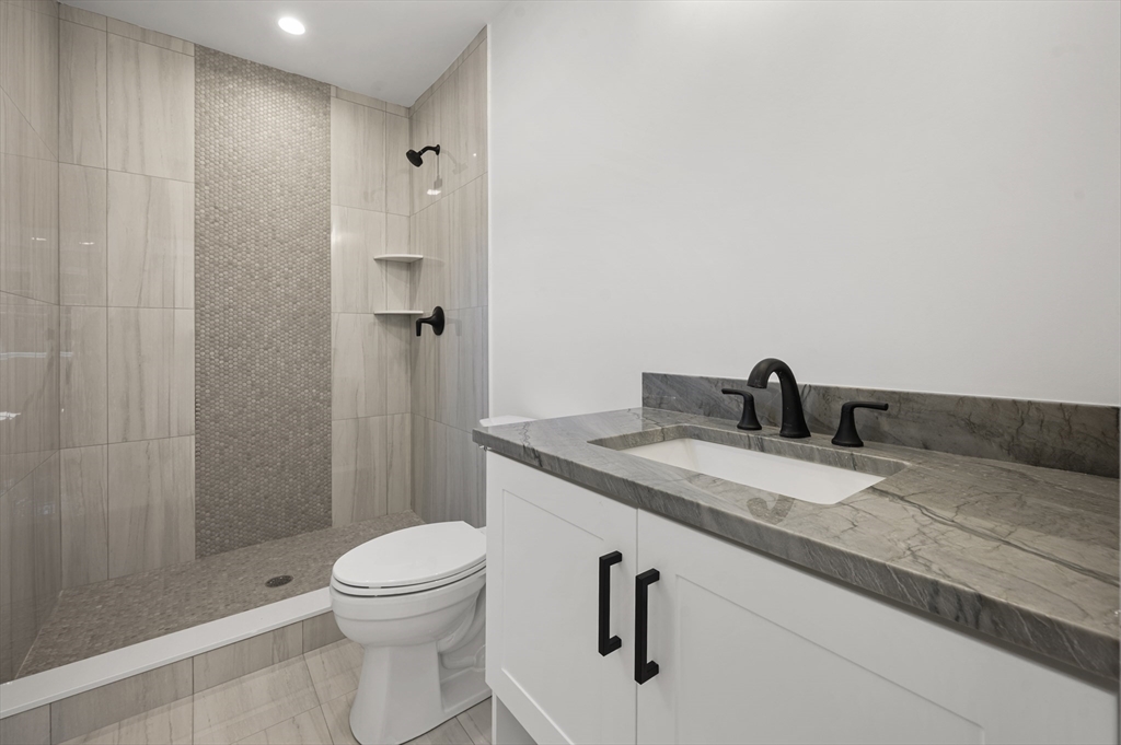 59 Henderson Street Needham, MA 02492 - Photo 22 of 32 a bathroom with a granite countertop sink toilet and shower