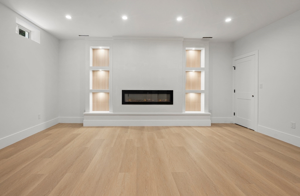 59 Henderson Street Needham, MA 02492 - Photo 26 of 32 a view of empty room with wooden floor and fan