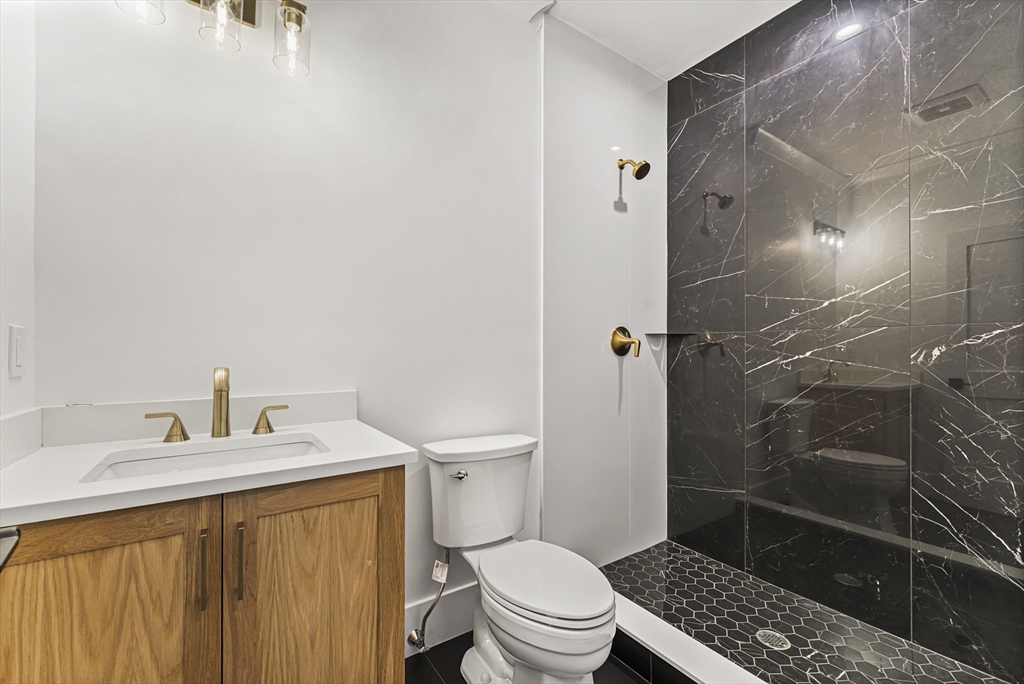 59 Henderson Street Needham, MA 02492 - Photo 27 of 32 a bathroom with a sink toilet and shower