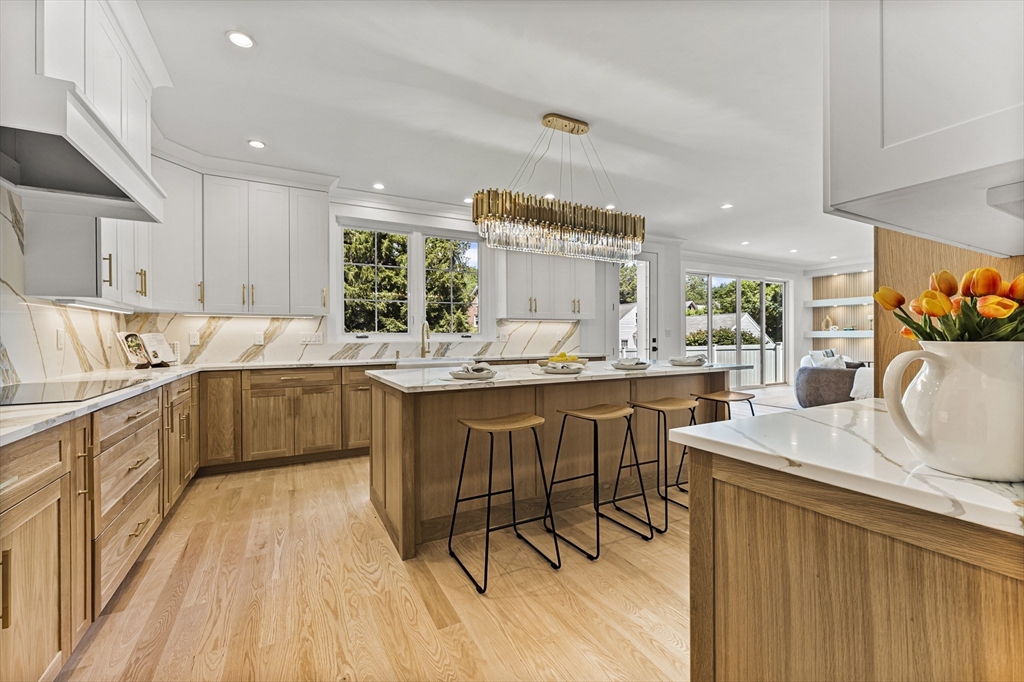 59 Henderson Street Needham, MA 02492 - Photo 9 of 32 a kitchen with a sink stove cabinets and wooden floor