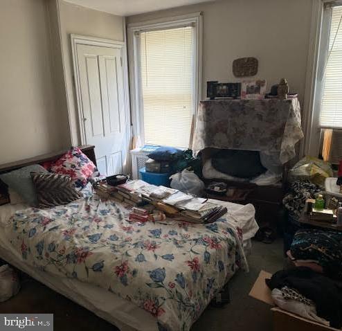 813 Arch Street Norristown, PA 19401 - Photo 11 of 18 a bedroom with a bed and a fireplace