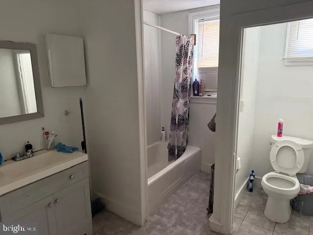 a bathroom with a granite countertop toilet a sink and a bathtub
