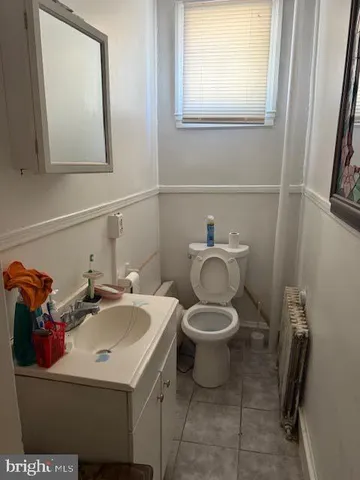 a bathroom with a sink mirror and toilet