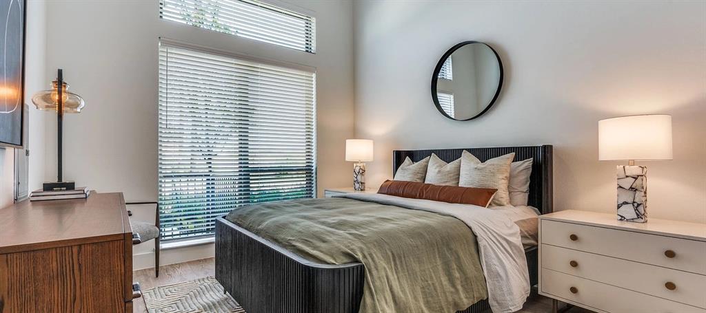 650 East Sycamore Street, Unit 1149 Denton, TX 76205 - Photo 4 of 19 a bedroom with a bed and a lamp on dresser next to a window