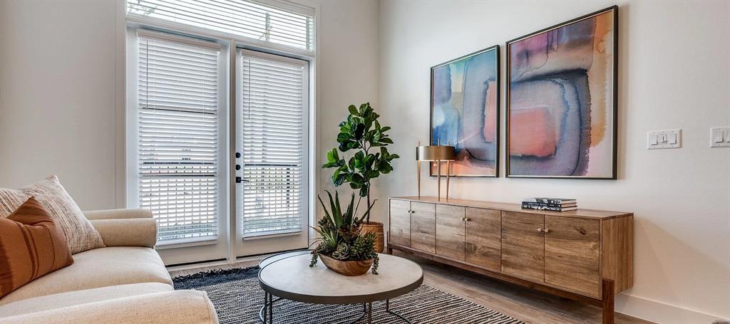 650 East Sycamore Street, Unit 1149 Denton, TX 76205 - Photo 6 of 19 a living room with furniture and a potted plant