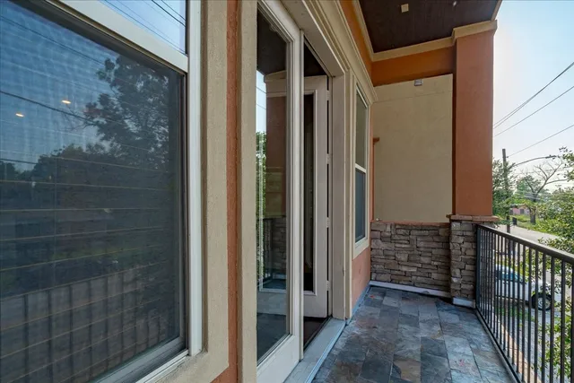 a view of a balcony with wooden floor
