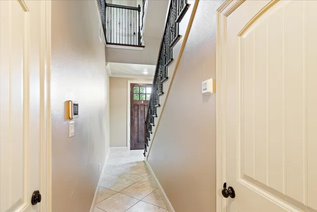 a view of a hallway with wooden floor and entryway