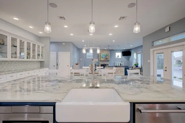 a kitchen with kitchen island a sink stainless steel appliances and cabinets