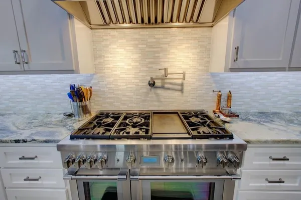 a kitchen with a stove and cabinets