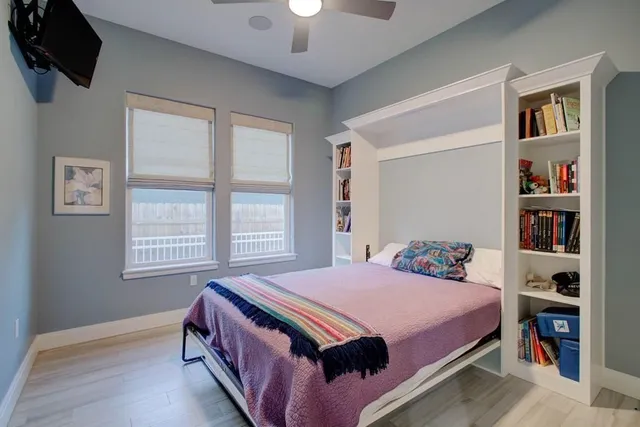 a bedroom with a bed dresser and a window