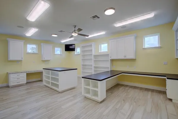 a kitchen with a sink and wooden floor