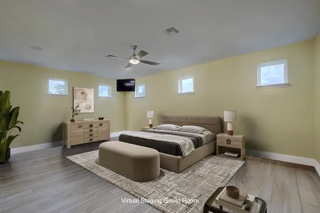 a bedroom with a bed and wooden floor