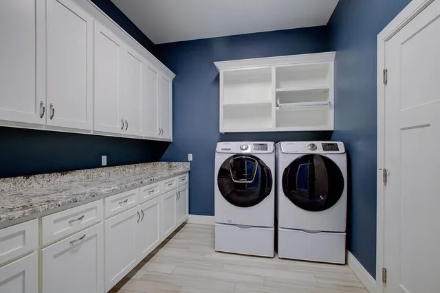 a kitchen with white cabinets and white appliances