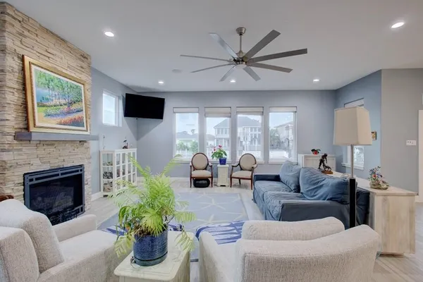 a living room with furniture a fireplace and a flat screen tv