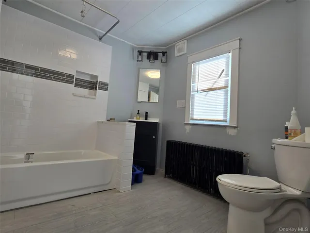 a bathroom with a sink a toilet and bathtub