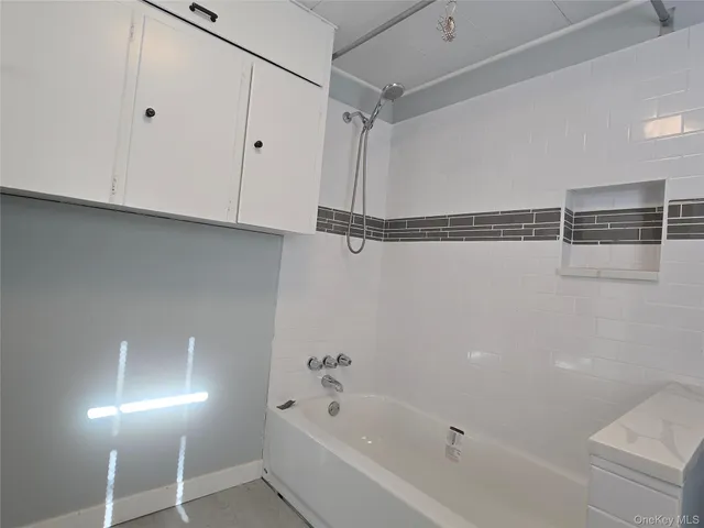 a bathroom with a bathtub and a shower