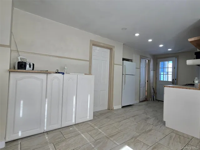 a view of a kitchen with a refrigerator