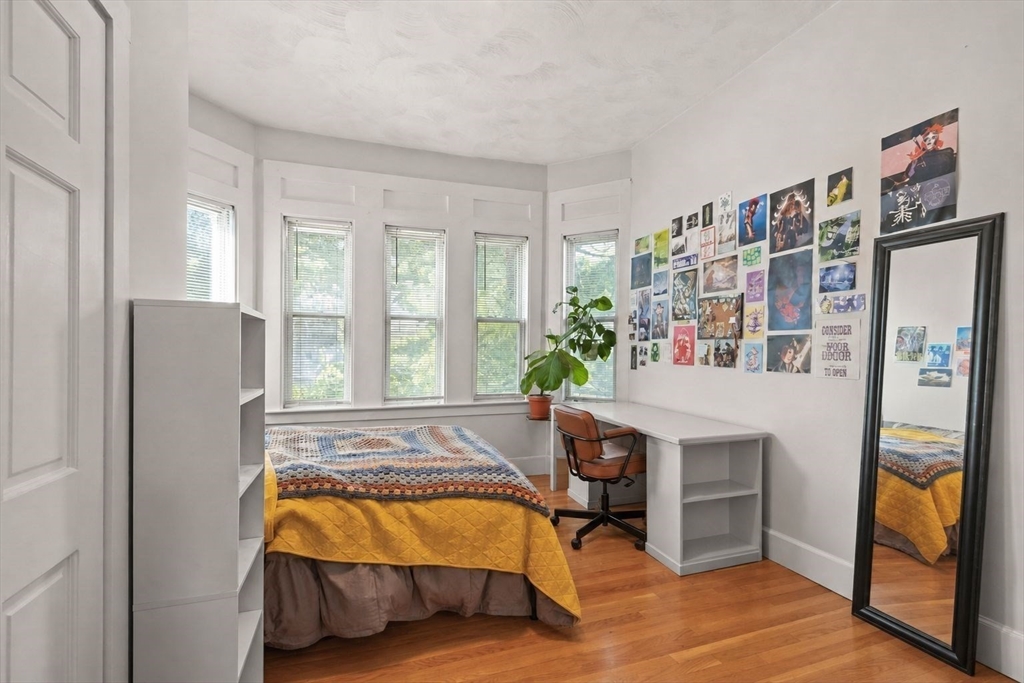 39 Union Street Boston, MA 02135 - Photo 17 of 33 a spacious bedroom with a bed and a large window