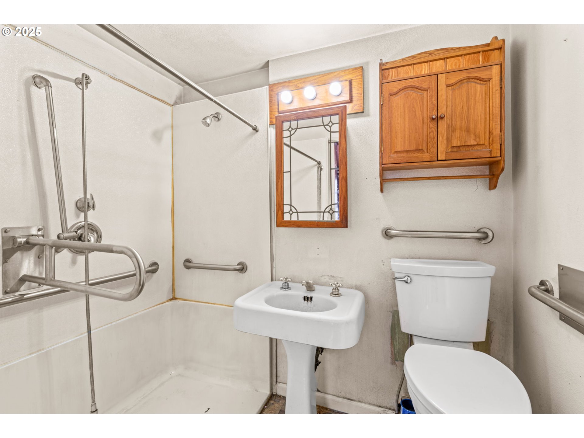 2665 C Street Springfield, OR 97477 - Photo 12 of 20 a bathroom with a sink a toilet and a mirror