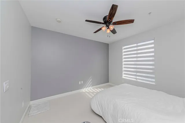 a bedroom with a bed and window