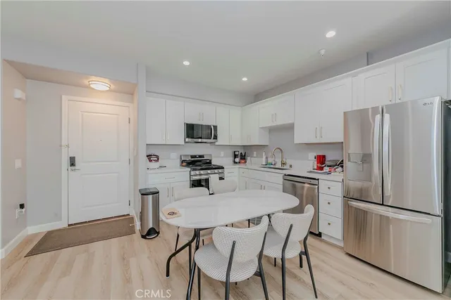 a kitchen with cabinets and wooden floor